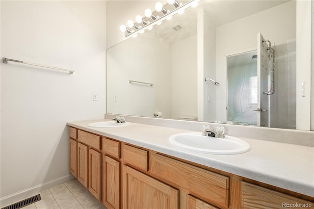 bathroom featuring tile patterned floors, vanity, and toilet