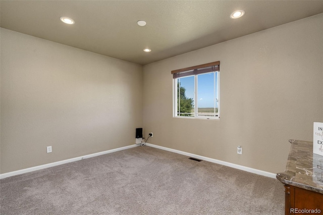 unfurnished room featuring carpet