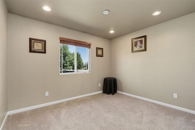 unfurnished room featuring carpet