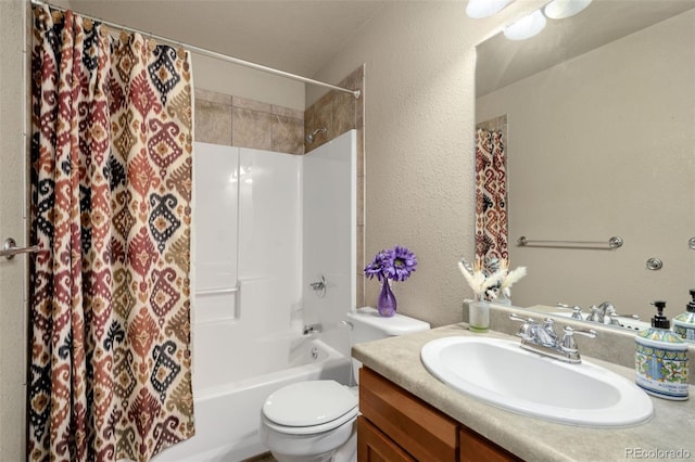 full bathroom with vanity, shower / tub combo, and toilet