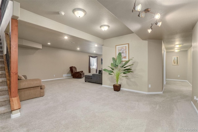 interior space featuring a textured ceiling and light carpet