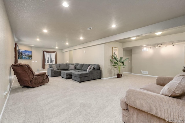 living room featuring a textured ceiling and light carpet