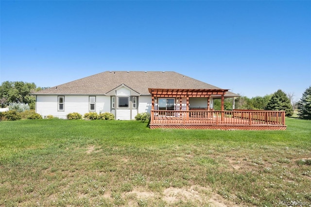 rear view of property with a pergola, a wooden deck, and a yard