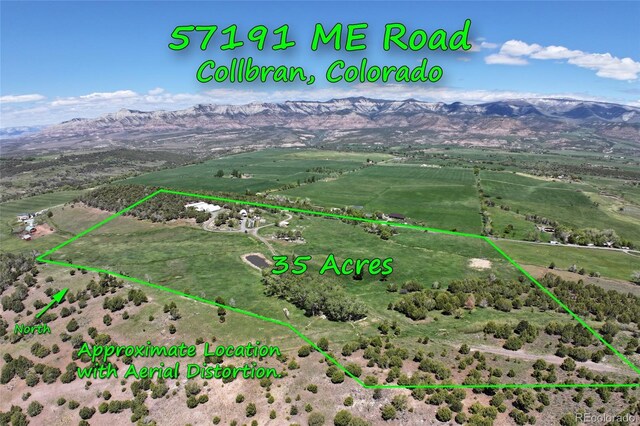57191 Me Rd, Collbran, CO 81624 - overview of rural landscape with a mountain backdrop and property boundaries highlighted