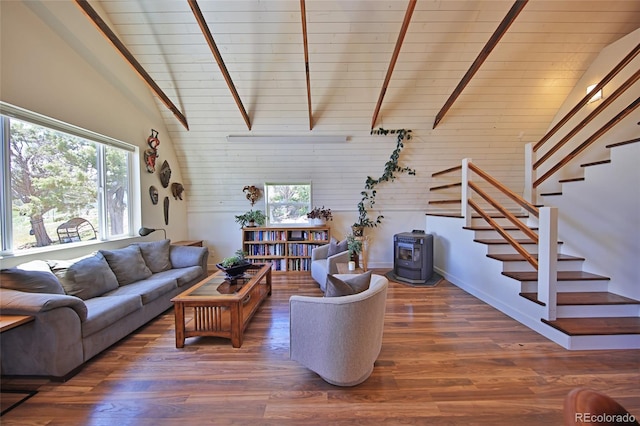 57191 Me Rd, Collbran, CO 81624 - living area with a wood stove, stairs, high vaulted ceiling, wood finished floors, and wooden walls