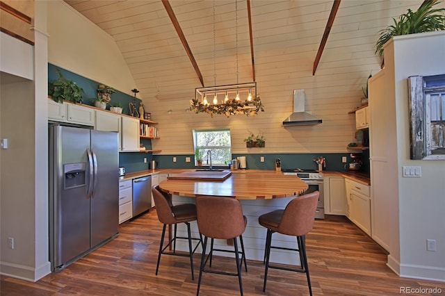 57191 Me Rd, Collbran, CO 81624 - kitchen with stainless steel appliances, butcher block countertops, wall chimney range hood, open shelves, and dark wood finished floors