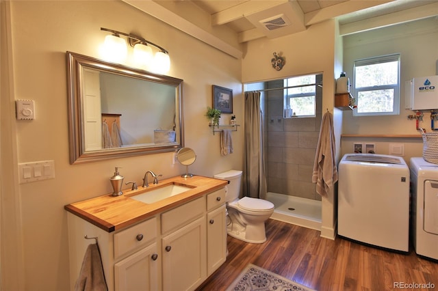 57191 Me Rd, Collbran, CO 81624 - full bathroom with independent washer and dryer, toilet, vanity, wood finished floors, and a stall shower