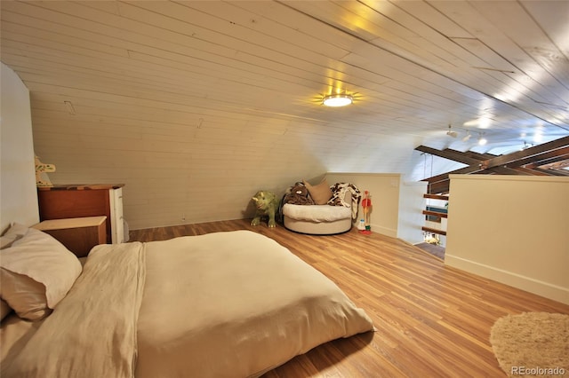 57191 Me Rd, Collbran, CO 81624 - bedroom with wood finished floors, wooden walls, and vaulted ceiling