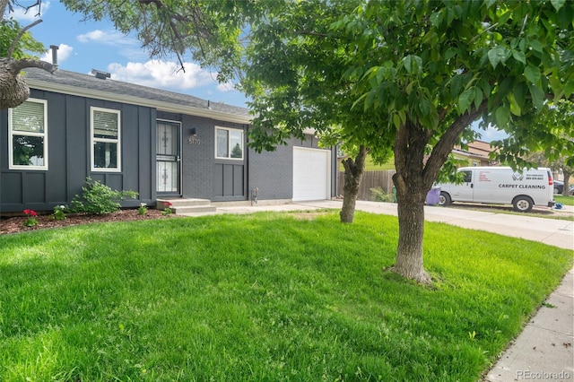 5170 Deephaven Ct, Denver, CO 80239 - view of front of home featuring driveway, a garage, board and batten siding, and roof with shingles