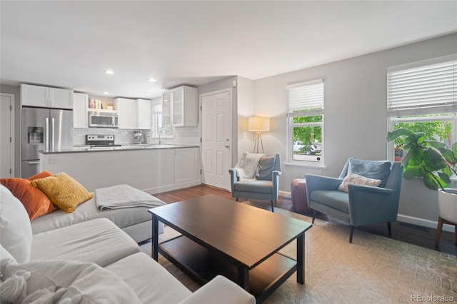 5170 Deephaven Ct, Denver, CO 80239 - living room with light wood-type flooring, baseboards, and recessed lighting
