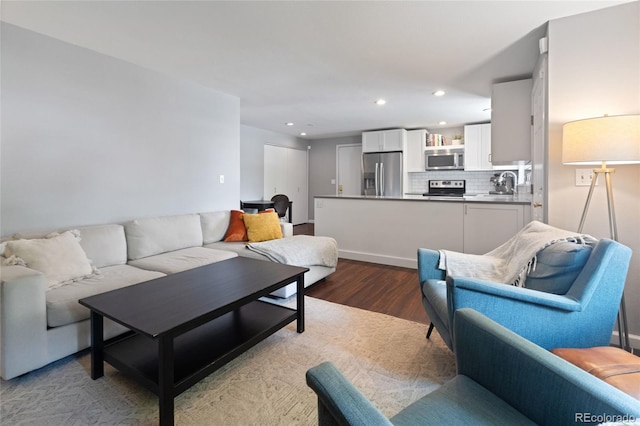 5170 Deephaven Ct, Denver, CO 80239 - living area featuring wood finished floors and recessed lighting