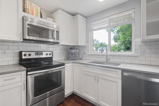 5170 Deephaven Ct, Denver, CO 80239 - kitchen with appliances with stainless steel finishes, a sink, light countertops, and white cabinets