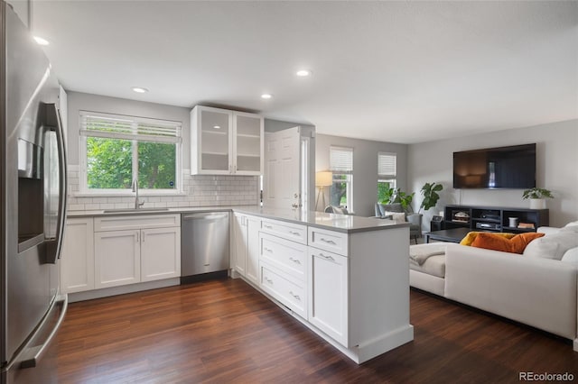 5170 Deephaven Ct, Denver, CO 80239 - kitchen with appliances with stainless steel finishes, a peninsula, a sink, open floor plan, and white cabinets
