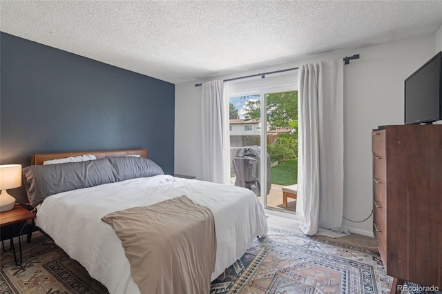 5170 Deephaven Ct, Denver, CO 80239 - bedroom with access to exterior and a textured ceiling
