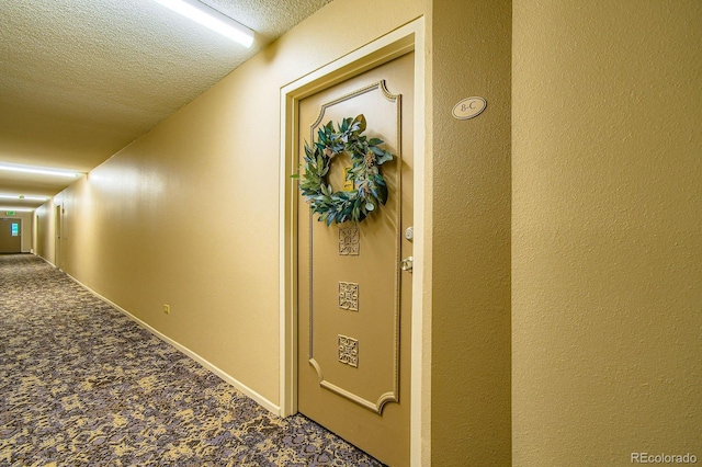 610 S Clinton St Unit 8C, Denver, CO 80247 - hallway with carpet flooring and a textured ceiling