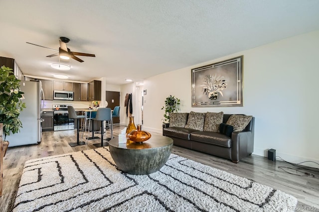 610 S Clinton St Unit 8C, Denver, CO 80247 - living room featuring light wood-style floors and a ceiling fan