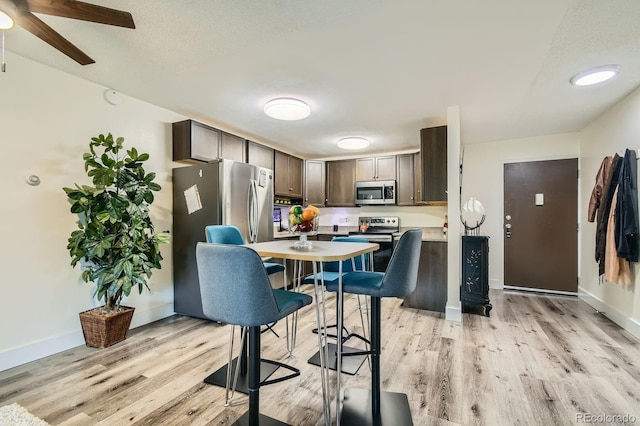 610 S Clinton St Unit 8C, Denver, CO 80247 - kitchen featuring appliances with stainless steel finishes, light wood-style flooring, light countertops, and dark brown cabinetry