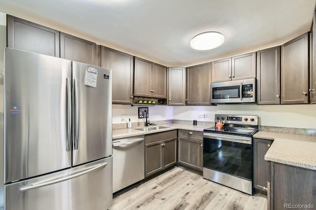 610 S Clinton St Unit 8C, Denver, CO 80247 - kitchen with appliances with stainless steel finishes, light wood finished floors, and light stone counters
