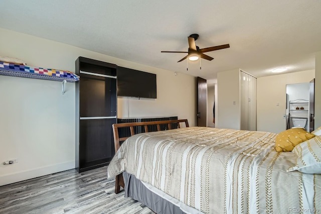 610 S Clinton St Unit 8C, Denver, CO 80247 - bedroom featuring wood finished floors and a closet