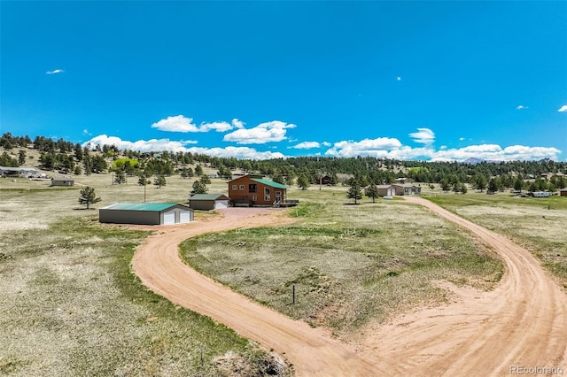 85 Estes Cir, Florissant, CO 80816 - view of home's community with an outbuilding, dirt driveway, a rural view, and a detached garage