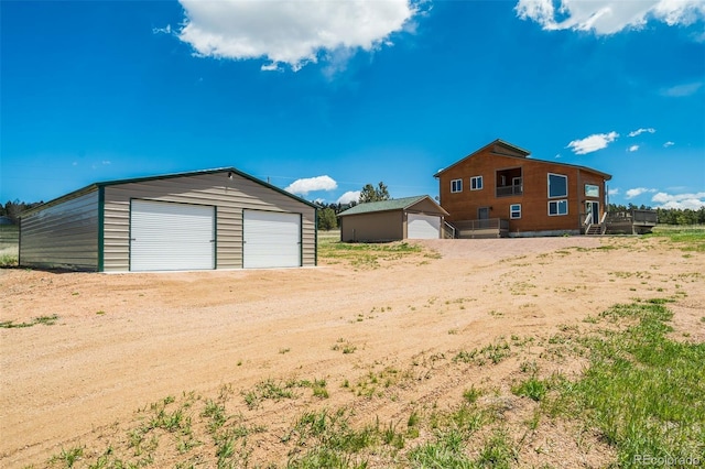 85 Estes Cir, Florissant, CO 80816 - view of yard featuring a detached garage and an outbuilding