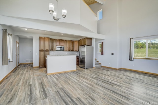 85 Estes Cir, Florissant, CO 80816 - kitchen with appliances with stainless steel finishes, light wood finished floors, brown cabinetry, baseboards, and recessed lighting