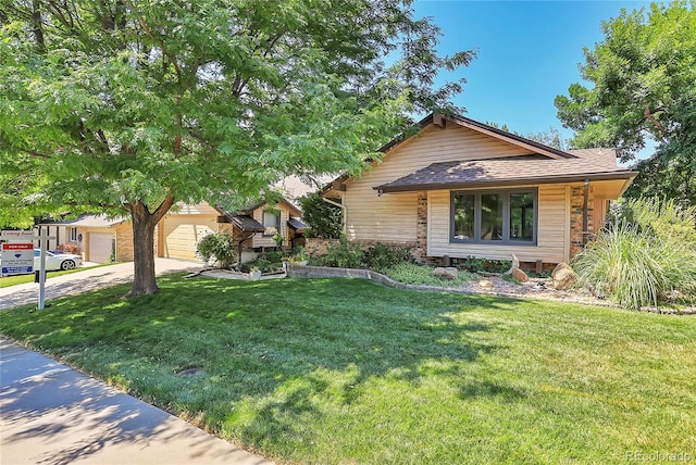 view of front of property with an attached garage, a shingled roof, a front lawn, and concrete driveway