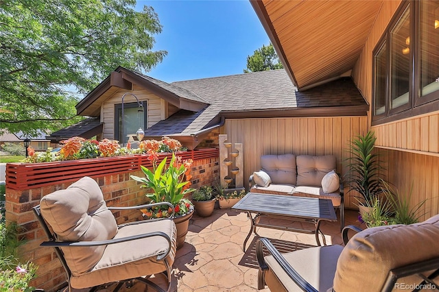 balcony with an outdoor hangout area and a patio