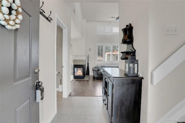 10540 Tracewood Cir, Highlands Ranch, CO 80130 - foyer featuring a multi sided fireplace and light tile patterned floors