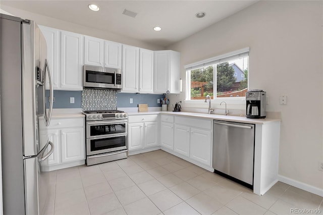10540 Tracewood Cir, Highlands Ranch, CO 80130 - kitchen with stainless steel appliances, light countertops, white cabinets, and recessed lighting