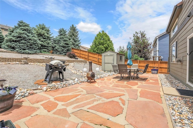 10540 Tracewood Cir, Highlands Ranch, CO 80130 - fenced backyard featuring a storage unit, a patio, outdoor dining area, and area for grilling