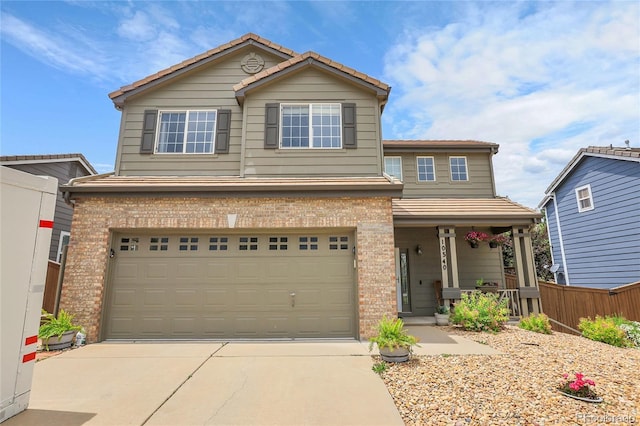 10540 Tracewood Cir, Highlands Ranch, CO 80130 - traditional-style home featuring brick siding, covered porch, an attached garage, driveway, and a tiled roof