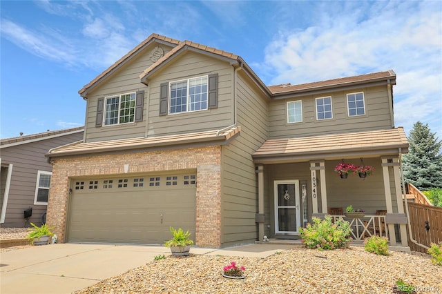 10540 Tracewood Cir, Highlands Ranch, CO 80130 - view of front of home with an attached garage, covered porch, concrete driveway, and brick siding