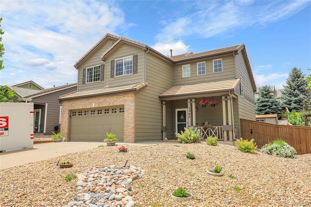 10540 Tracewood Cir, Highlands Ranch, CO 80130 - view of front facade featuring an attached garage, a porch, concrete driveway, and brick siding