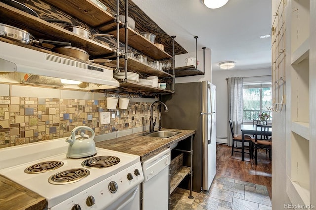 kitchen featuring a sink, a baseboard heating unit, stone tile flooring, white appliances, and open shelves