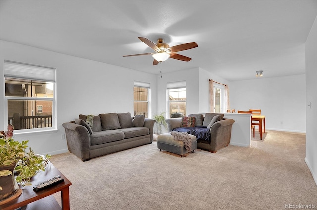 carpeted living room featuring ceiling fan