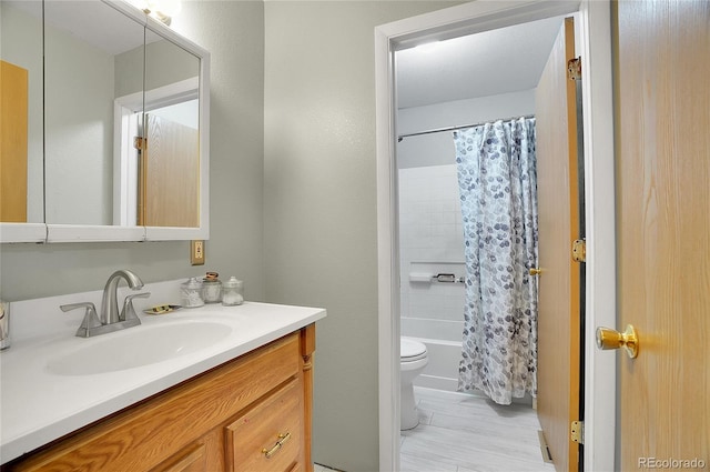 full bathroom featuring vanity, shower / bathtub combination with curtain, and toilet