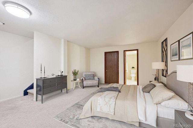 bedroom featuring carpet floors and ensuite bath