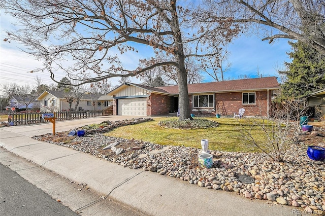 ranch-style house featuring a garage and a front lawn