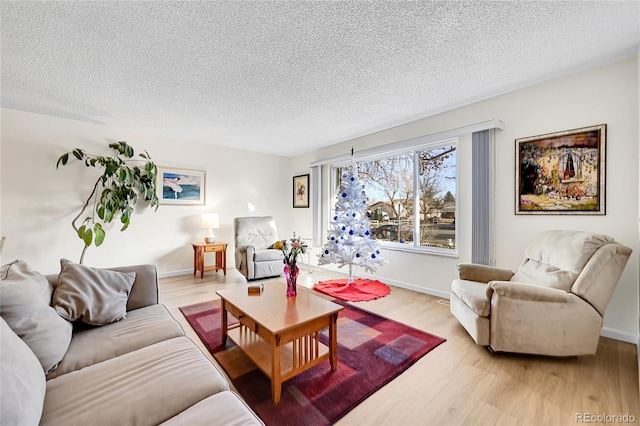 living room featuring a textured ceiling and light wood-type flooring