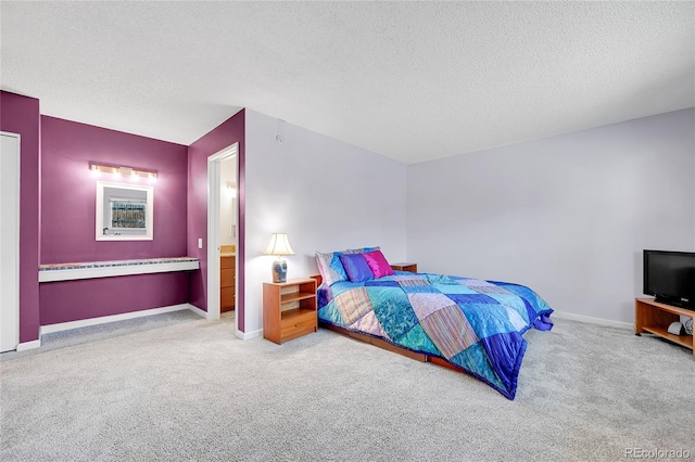 carpeted bedroom featuring a textured ceiling