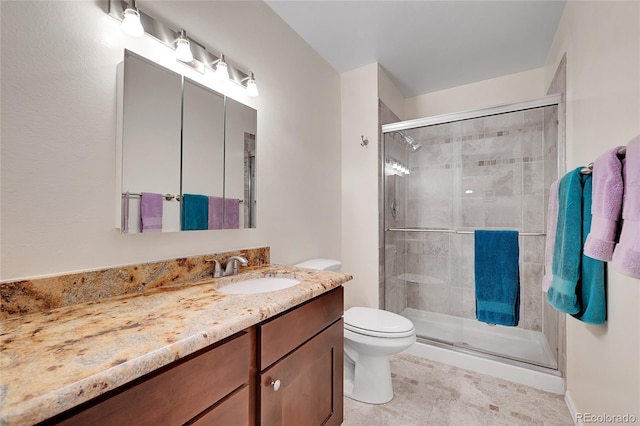 bathroom featuring vanity, toilet, and an enclosed shower