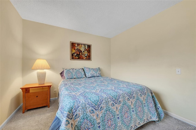 carpeted bedroom featuring a textured ceiling