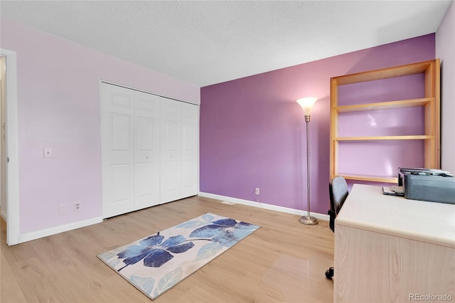 office space with light hardwood / wood-style floors and a textured ceiling