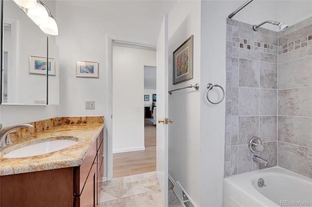 bathroom with vanity and tiled shower / bath combo