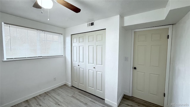 unfurnished bedroom with ceiling fan, a closet, and light hardwood / wood-style flooring