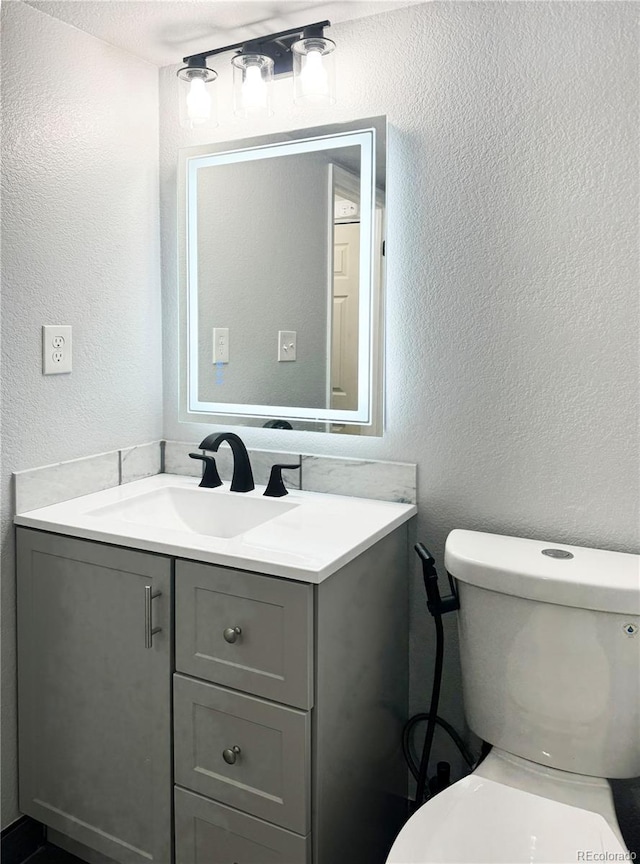 bathroom with toilet and vanity