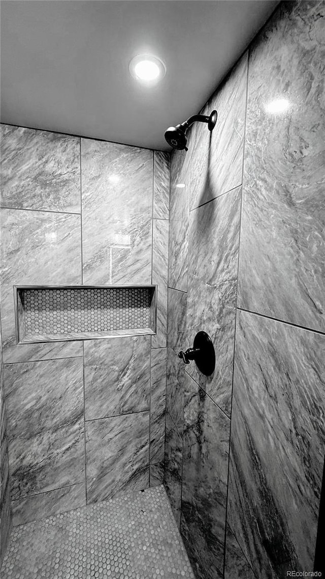 bathroom with a tile shower