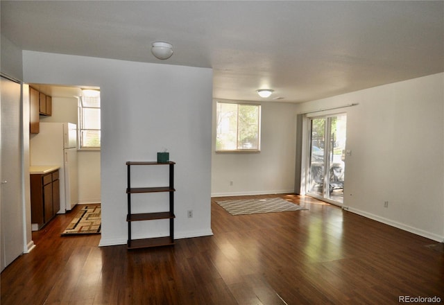 empty room featuring dark wood-style flooring and baseboards