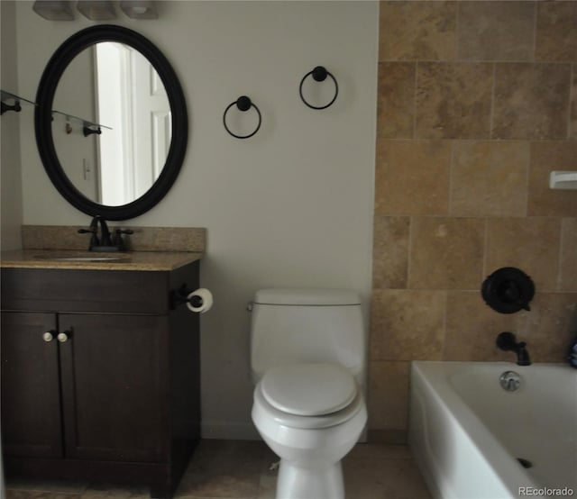 bathroom featuring baseboards, vanity, toilet, shower / bath combination, and tile patterned floors